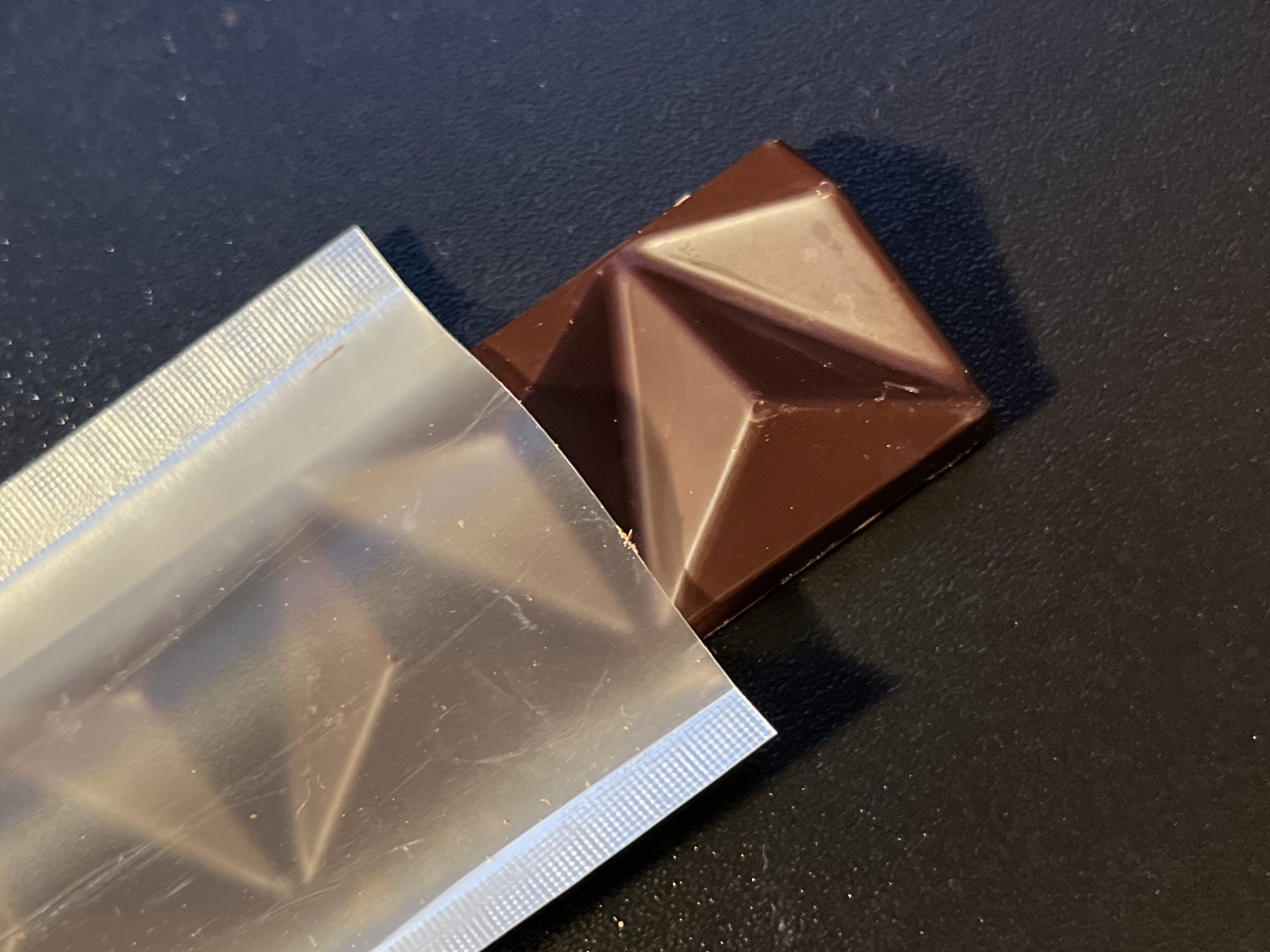 open package of a chocolate bar with end sticking out